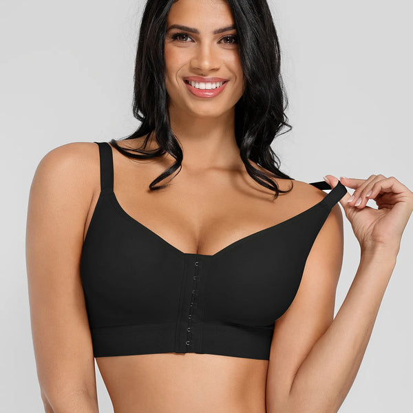 A woman modeling a black wireless bra with a center-button closure, shown against a light gray studio background.