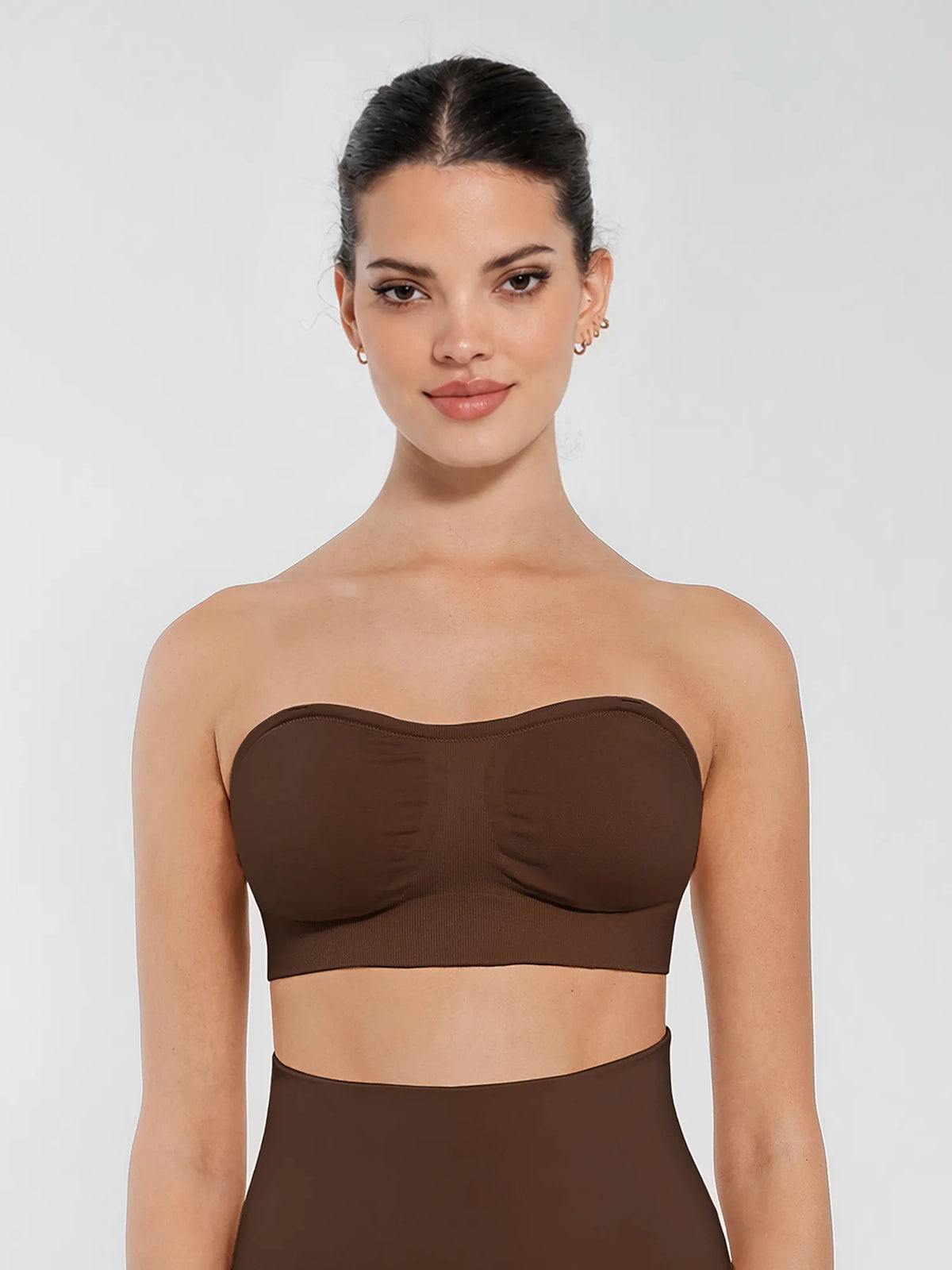 Front profile of a dark brown strapless bandeau bra showing secure silicone lining and bust-lifting fit