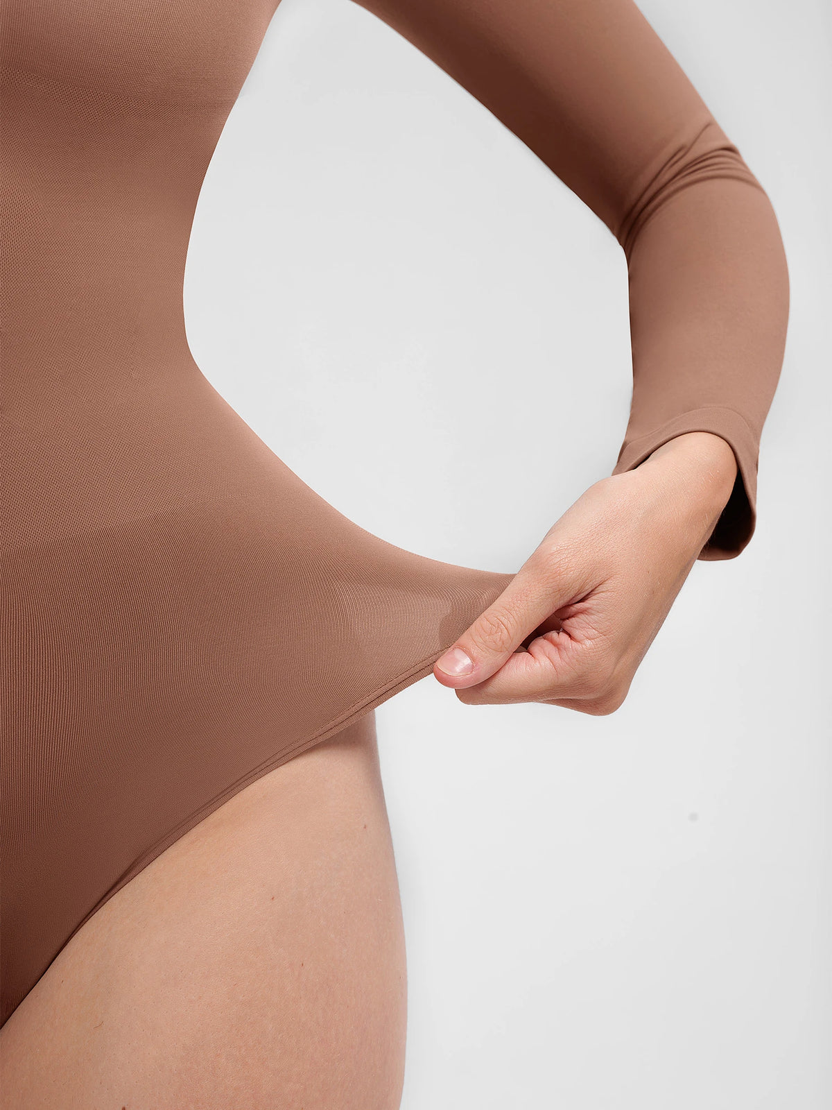 Shop a high neck seamless bodysuit with buttery-soft fabric, light tummy control, and a second-skin fit. Versatile for layering, work, and everyday wear.